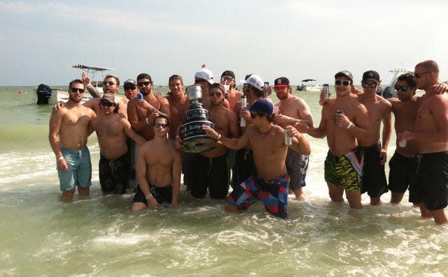 Florida Everblades players celebrate with the Kelly Cup on Fort Myers Beach. Florida won the Cup, the ECHL's championship trophy, on May 23, 2012.