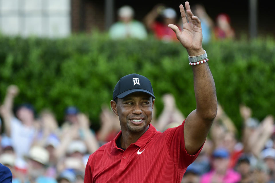 FILE - Tiger Woods celebrates on the 18th green after wining the Tour Championship golf tournament Sunday, Sept. 23, 2018, in Atlanta. Woods will be the star attraction in the World Golf Hall of Fame induction ceremony Wednesday, March 9, 2022. (AP Photo/John Amis, File)