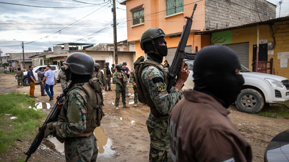 Ecuadorian soldiers search a neighborhood for illegal weapons during an anti-gang operation in Guayaquil on February 5. - John Moore/Getty Images