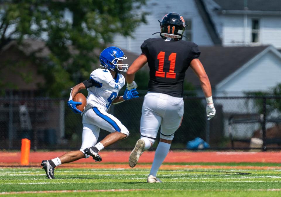 Mastery of Camden's Cassidy Jenkins (9) runs the ball against Somerville's Andrew DeAngelis (11) on Saturday, Aug. 27 at the Somerville high school football field.