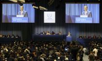 Acting Director General of the International Atomic Energy Agency, IAEA, Cornel Feruta from Romania is seen on screens as he delivers a speech at opening of the general conference of the IAEA, at the International Center in Vienna, Austria, Monday, Sept. 16, 2019. (AP Photo/Ronald Zak)