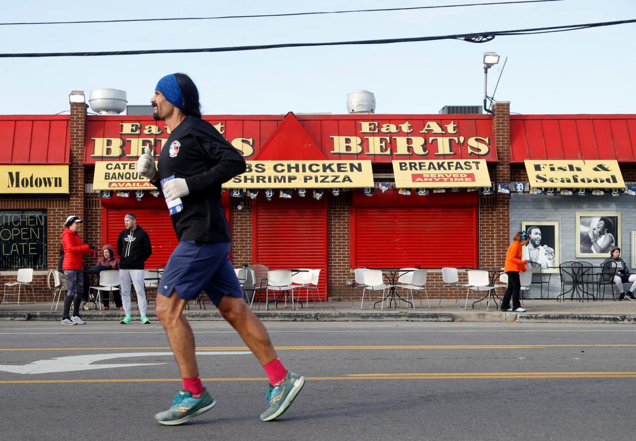 A marathon runner passes by the well know Bert's restaurant at Eastern Market on Russell Street during the 45th Annual Detroit Free Press Marathon in Detroit on Sunday, Oct. 16, 2022.