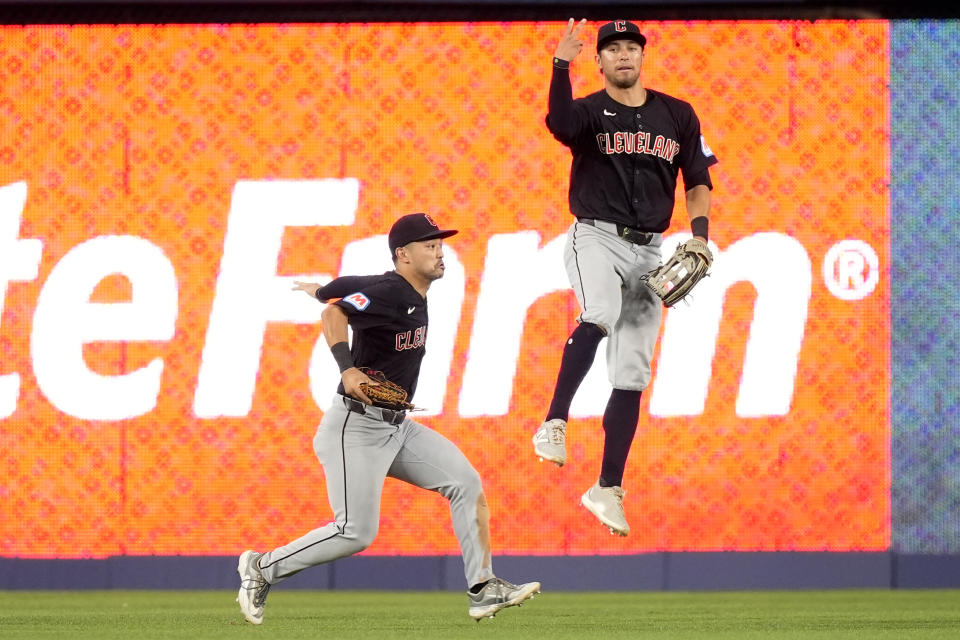 Cleveland Guardians left fielder Steven Kwan, left, and center fielder Tyler Freeman celebrate after defeating the Miami Marlins in a baseball game, Sunday, June 9, 2024, in Miami. (AP Photo/Lynne Sladky)