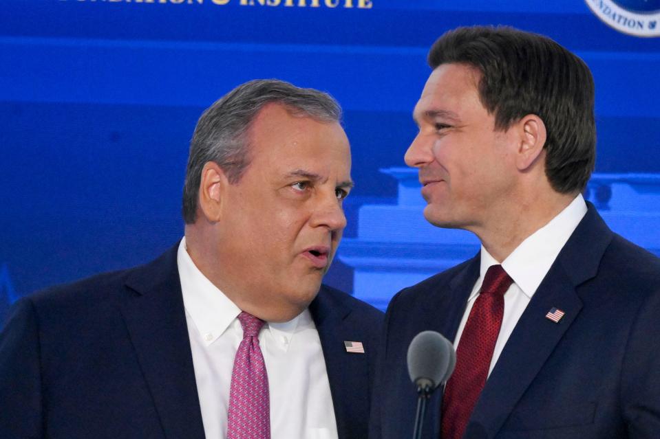 Former New Jersey Gov.ÊChris Christie speaks with Florida Gov.ÊRon DeSantis during a break in the FOX Business Republican presidential primary debate at the Ronald Reagan Presidential Library and Museum.