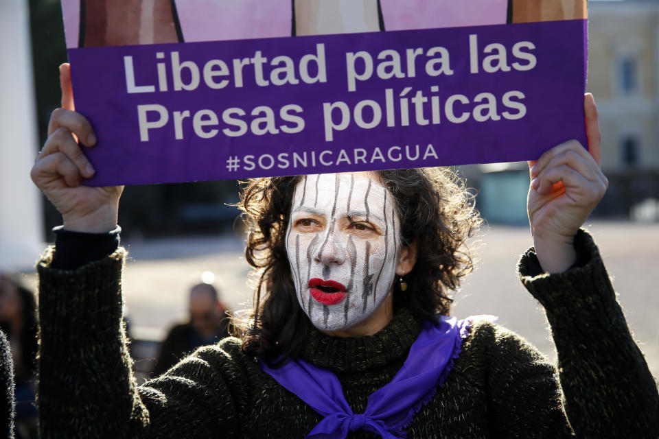 FILE - In this Jan. 12, 2019 file photo, a demonstrator holds a placard reading in Spanish: "Liberty for female political prisoners" during a protest against the Nicaraguan government in Madrid, Spain. The Madres de Abril (Spanish for Mothers of April) group is gearing up for a potentially years-long fight against the government of Nicaraguan President Daniel Ortega in its quest for accountability and justice for the hundreds of people killed in the government suppression of protests since April 2018. (AP Photo/Andrea Comas, File)