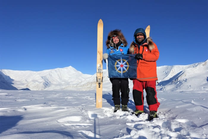 Lonnie dupre alongside another explorer holding rcgs flag