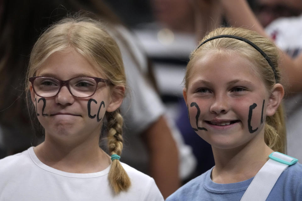 Fans watch Indiana Fever guard Caitlin Clark warm up before a WNBA basketball game against the New York Liberty, Thursday, May 16, 2024, in Indianapolis. (AP Photo/Michael Conroy)