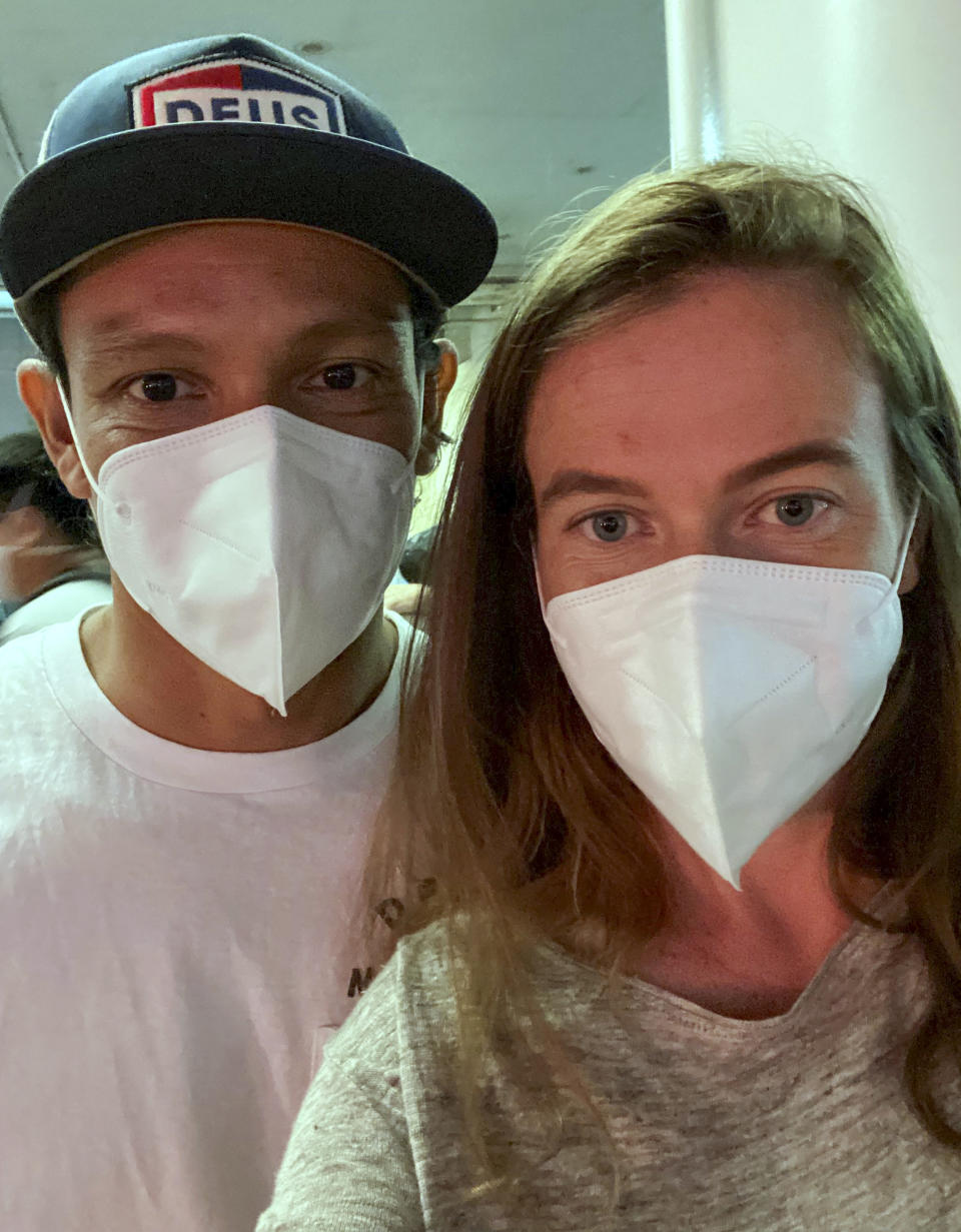 New Zealander Bergen Graham and her husband Oscar Acevedo wait to check in at Los Angeles Airport, on Sept. 14, 2021. As part of its efforts to minimize the spread of the coronavirus, New Zealand requires all incoming travelers, vaccinated or not, to spend 14 days isolating in a hotel run by the military. Because demand is far outstripping supply, New Zealanders are being forced to put on hold their inalienable right to return home. (Bergen Graham via AP)