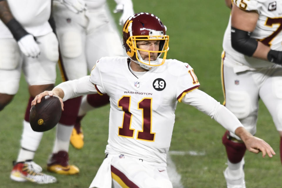 Washington Football Team quarterback Alex Smith (11) looks to throw a pass during the first half of an NFL football game against the Pittsburgh Steelers in Pittsburgh, Monday, Dec. 7, 2020. (AP Photo/Barry Reeger)