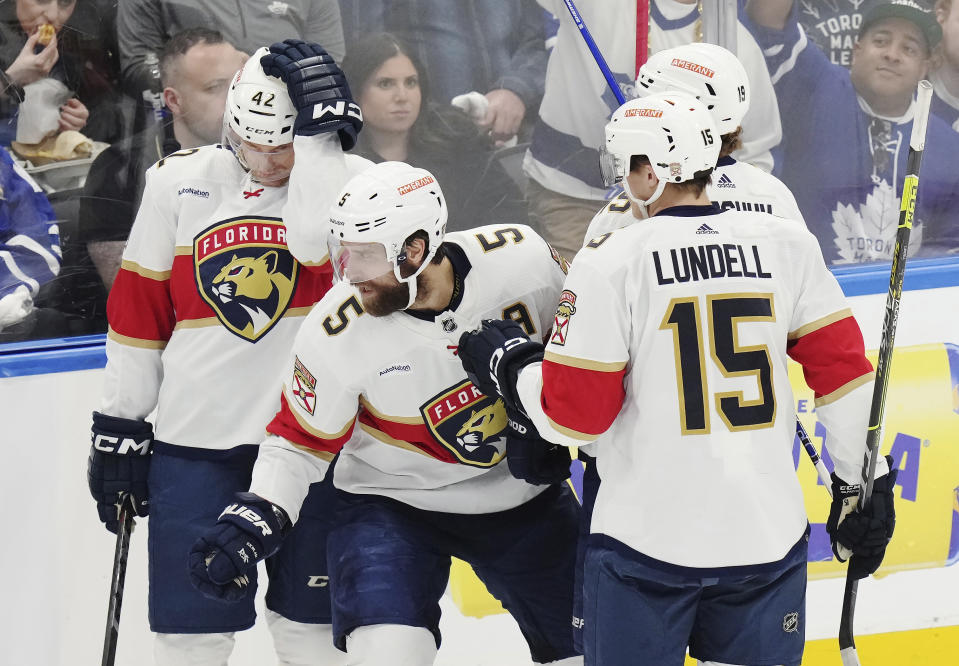 Florida Panthers defenseman Aaron Ekblad (5) celebrates his goal against the Toronto Maple Leafs with defenseman Gustav Forsling (42), forward Anton Lundell (15) and forward Matthew Tkachuk (19) during the first period of Game 5 of an NHL hockey Stanley Cup second-round playoff series Friday, May 12, 2023, in Toronto. (Chris Young/The Canadian Press via AP)