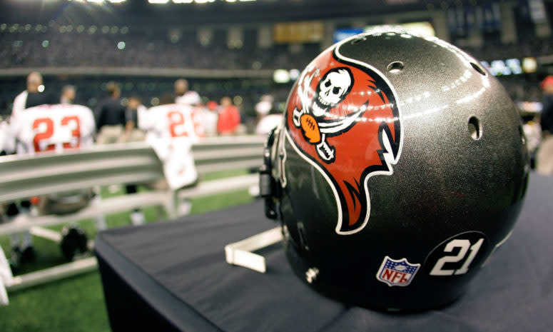 A Tampa Bay Buccaneers helmet sitting on the sideline.