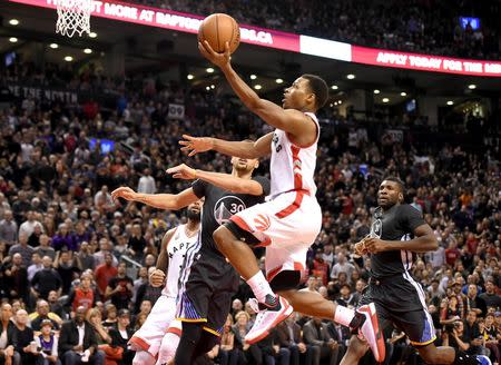 Dec 5, 2015; Toronto, Ontario, CAN; Toronto Raptors guard Kyle Lowry scores on a lay up in the second half against Golden State Warriors at Air Canada Centre. The Warriors won 112-109. Mandatory Credit: Dan Hamilton-USA TODAY Sports