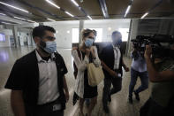 Aya Biran, center, a paternal aunt of Eitan Biran, who survived a cable car crash in Italy that killed his immediate family, leaves court in Tel Aviv on Thursday, Sept. 23, 2021 after a hearing in the alleged kidnapping of her nephew. The boy's parents and younger sibling were among 14 killed in May when a cable car slammed into a mountainside in northern Italy. He is now the focus of a custody battle between his maternal grandparents in Israel and his paternal relatives in Italy. (AP Photo/Sebastian Scheiner)