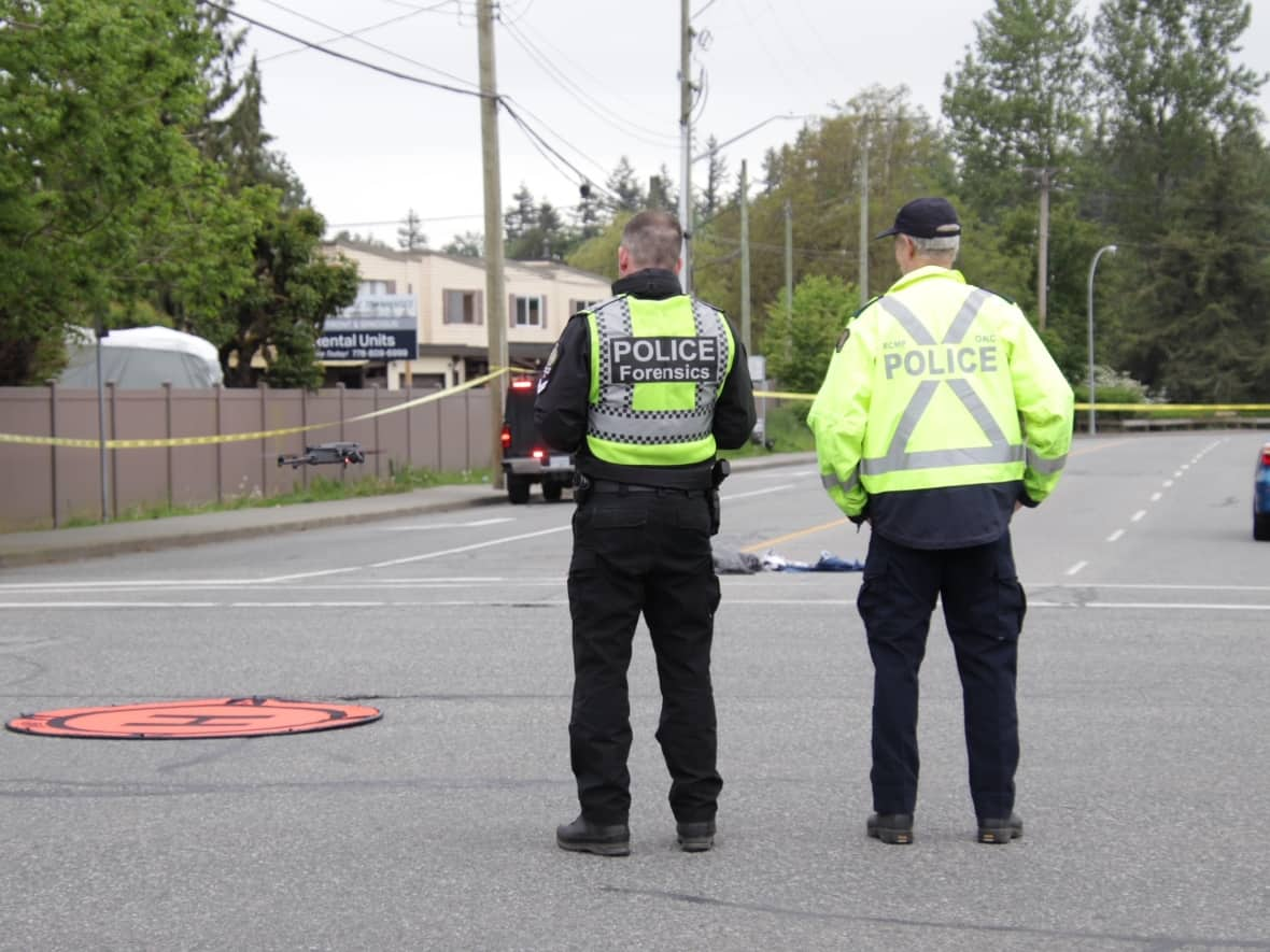 Police are seen at the scene of a serious pedestrian-car collision in Abbotsford on May 26, 2022. Two seniors were hospitalized with life-threatening injuries after the collision. (Shane MacKichan - image credit)