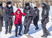 Police officers detain a woman during a protest against the jailing of opposition leader Alexei Navalny in Khabarovsk, 6,100 kilometers (3,800 miles) east of Moscow, Russia, on Sunday, Jan. 31, 2021. Thousands of people took to the streets Sunday across Russia to demand the release of jailed opposition leader Alexei Navalny, keeping up the wave of nationwide protests that have rattled the Kremlin. Hundreds were detained by police. (AP Photo/Igor Volkov)