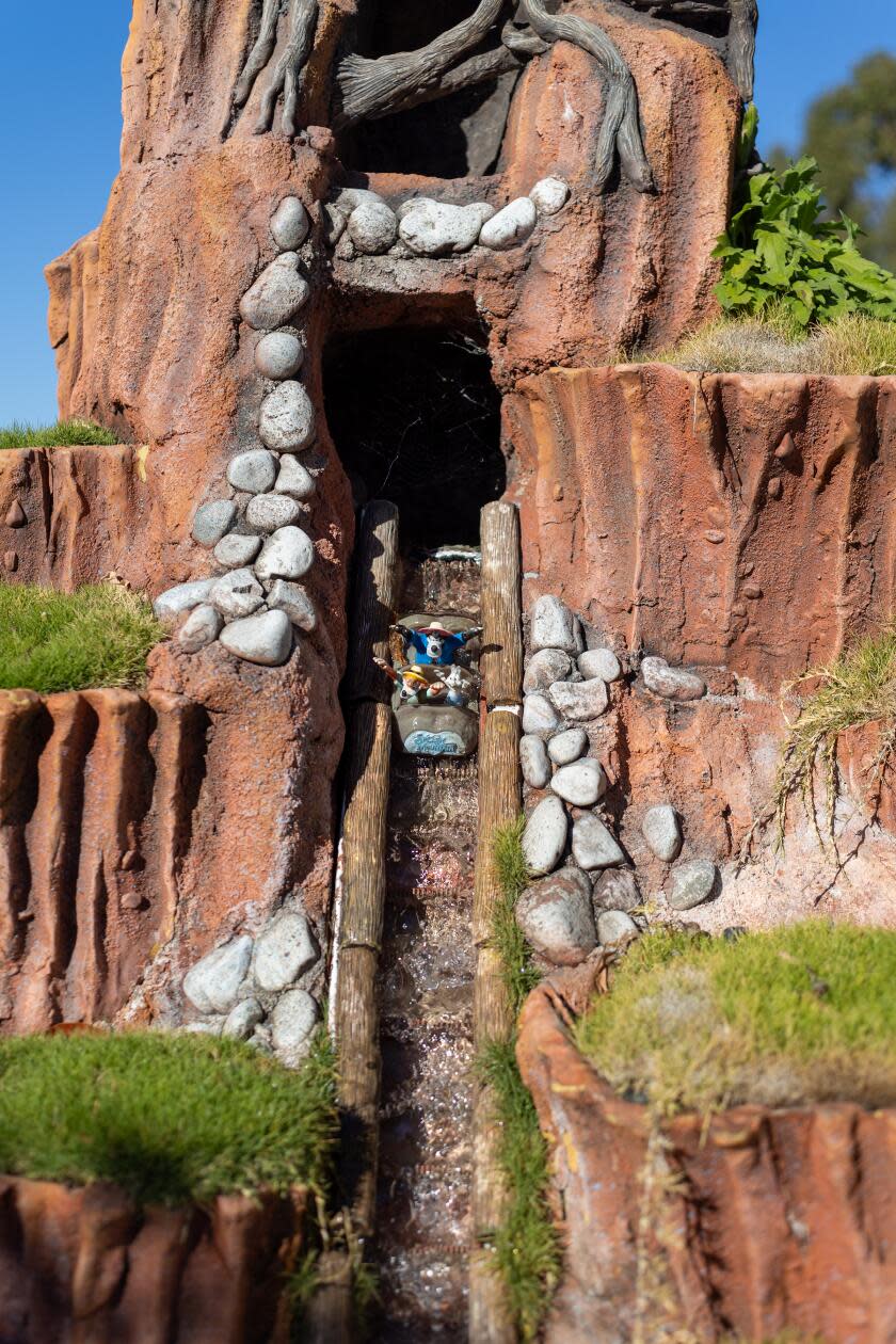 Mini-riders descend down the slope of a shrunken-down Splash Mountain.