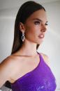 Alessandra Ambrosio stuns as she gets ready in a sequined purple dress.