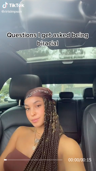 Riley in her car on TikTok with the words, "Questions I get asked being biracial"