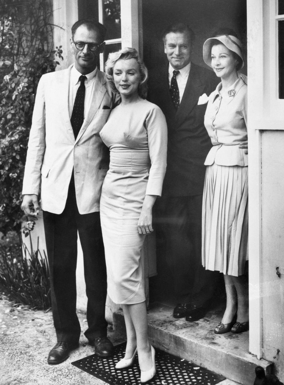 <p>Miller was the actress's third and last husband. Here, they meet with Sir Laurence Olivier and his wife, Vivien Leigh, while vacationing in England.</p>