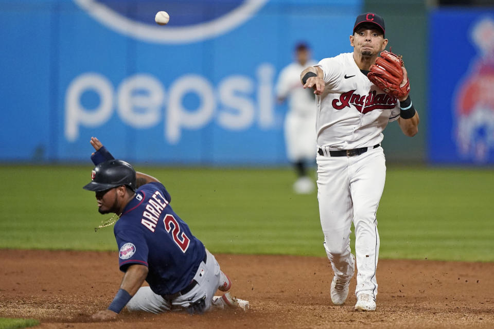 Cleveland Indians' Andres Gimenez throws to first after forcing out Minnesota Twins' Luis Arraez at second during the eighth inning of a baseball game Wednesday, Sept. 8, 2021, in Cleveland. Byron Buxton was safe at first. The Twins won 3-0. (AP Photo/Tony Dejak)