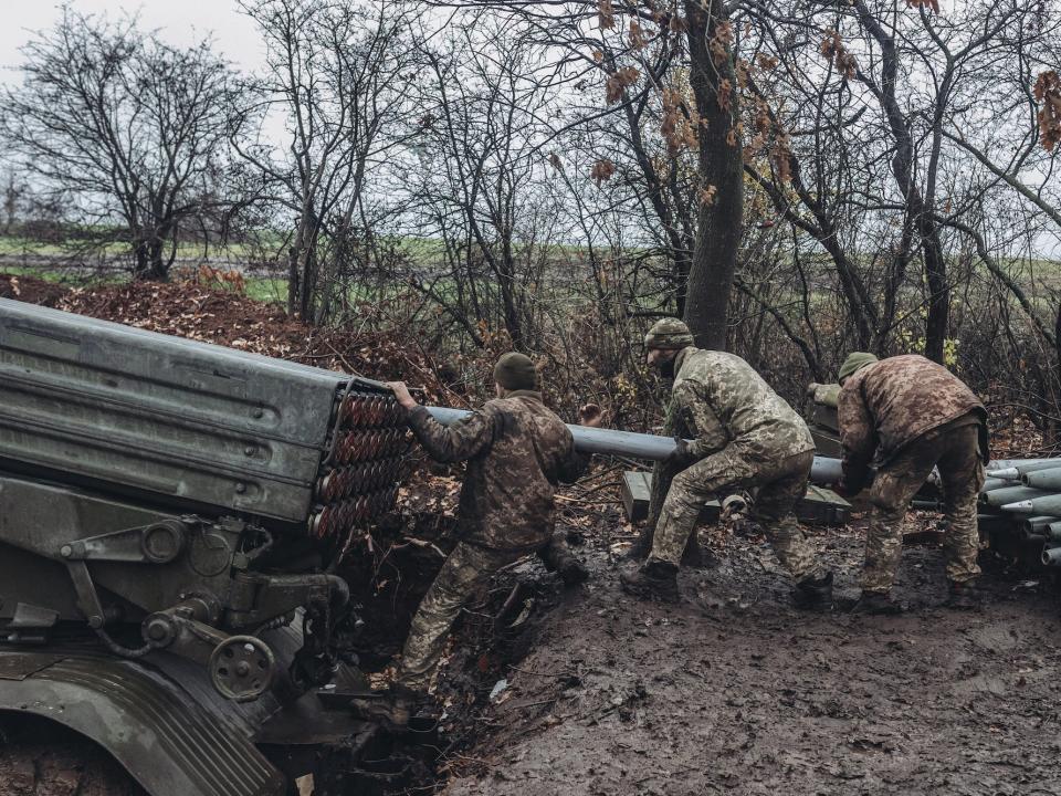 Ukrainian soldiers reload a Grad multiple-launch rocket system