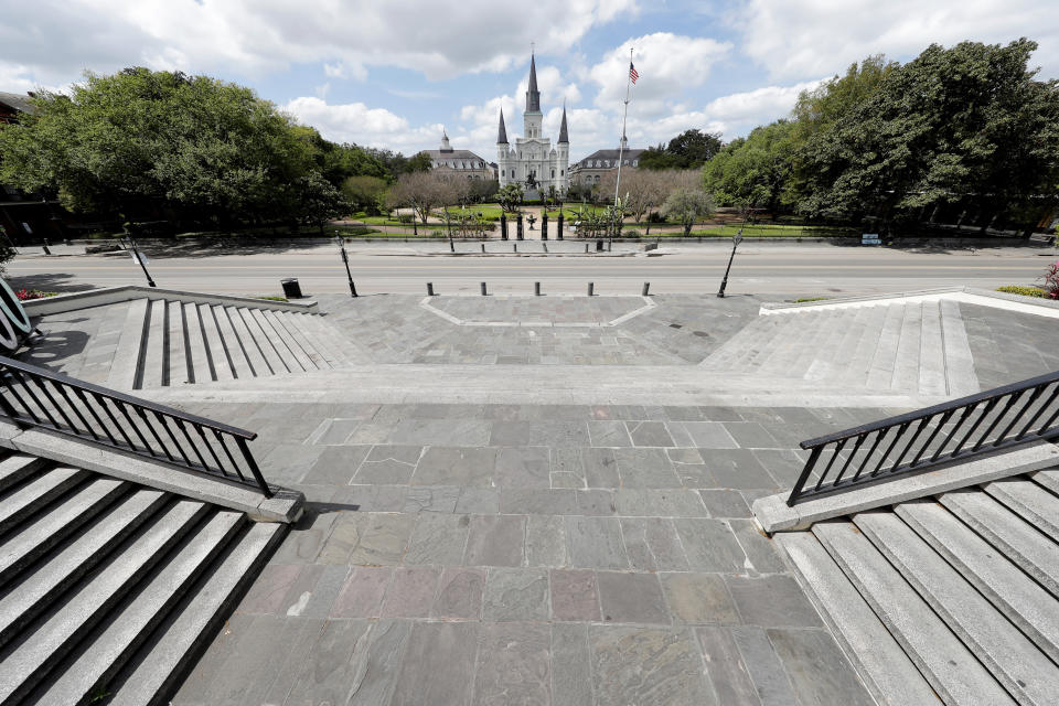 Jackson Square, normally bustling with tourists, is seen deserted in the French Quarter of New Orleans, due to the new coronavirus pandemic, Friday, March 27, 2020. While rich in history and culture, New Orleans is economically poor, and the people here are not necessarily well-positioned to weather this latest storm. (AP Photo/Gerald Herbert)