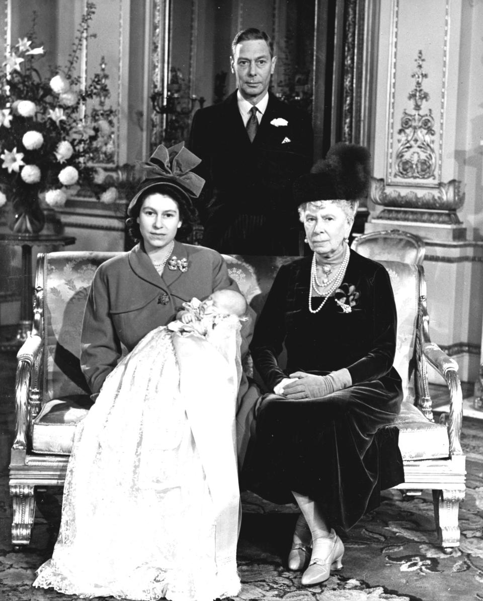 FILE - In this Dec. 15, 1948 file photo, Britain's Princess Elizabeth, later Queen Elizabeth II, holds her son Prince Charles at Buckingham Palace, following his christening. Seated at right is her grandmother Queen Mary, the mother of her father, King George VI, background. Prince Charles is readying the paperwork to claim his pension when he turns 65 on Thursday, Nov. 14, 2013, but he still hasn't started the job he was born to do. (AP Photo, Pool, File)