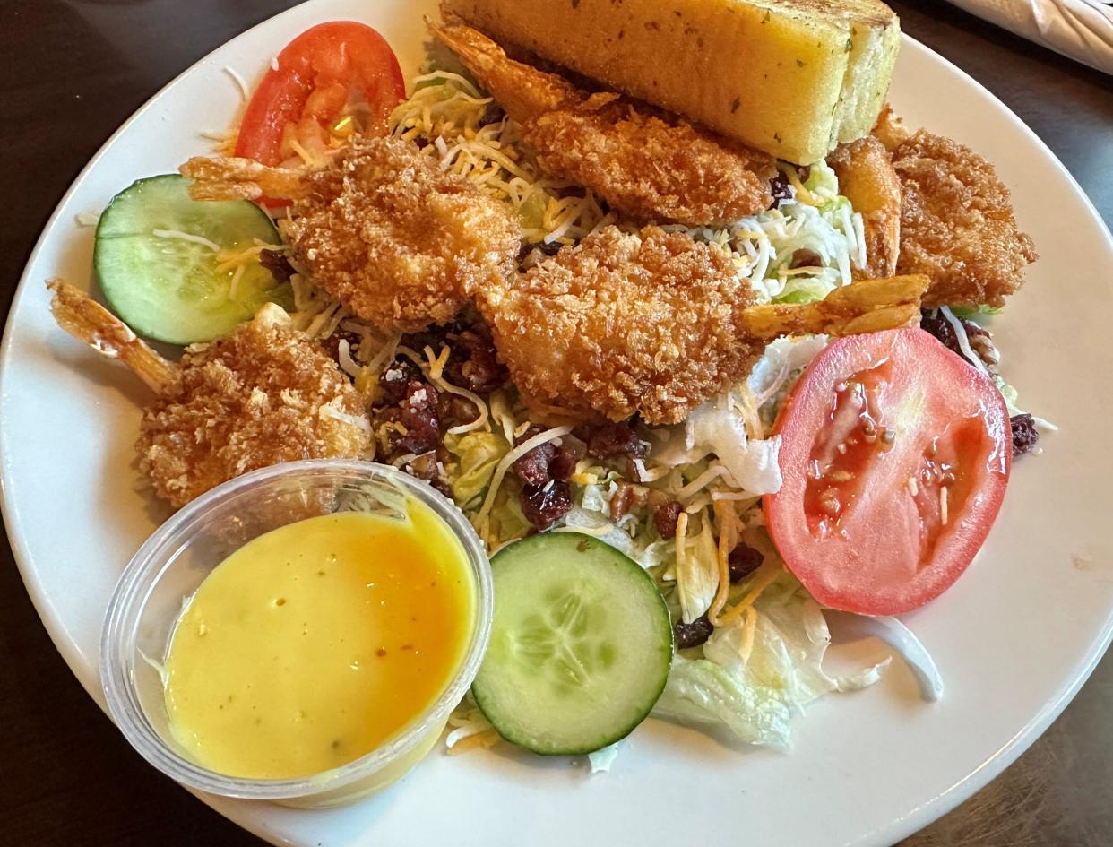 Pecan cranberry salad, with choice of shredded lettuce or spring mix is a refreshing entree choice at Miller-Doan Tavern in Canal Fulton. While the menu has it served with chicken, it can be substituted with fried shrimp.