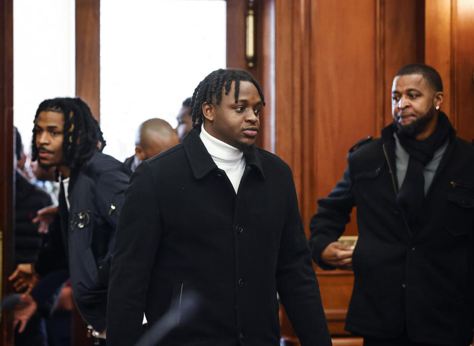 Davonte Pack, center, friend to Memphis Grizzlies player Ja Morant, left, enters Judge Carol Chumney's courtroom at Shelby County Circuit Court on Monday, Dec. 11, 2023, in Memphis, Tenn. The hearing is to determine whether Morant used self defense during a fight last summer at his home. (Mark Weber/Daily Memphian via AP)