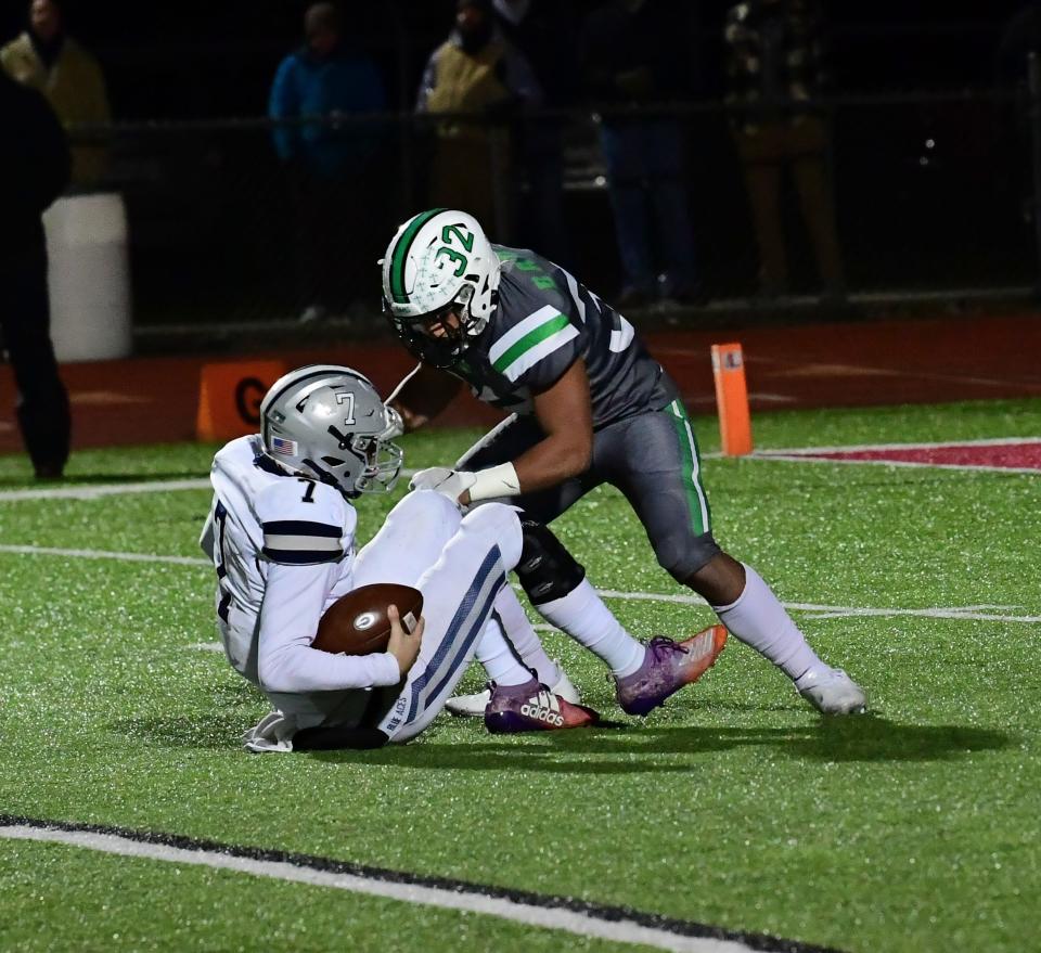 Badin's Kaden Starks (32) sacks Granville quarterback Carsyn Crouch inside the 10-yard line for the Rams at the OHSAA Division III state football semifinals, Nov. 26, 2021.