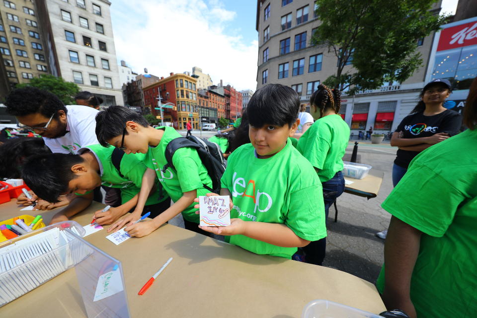 <p>A student from I.S. 117 Joseph H. Wade in the Bronx holds up an art board he created, in Union Square Park in New York City on June 5, 2018. (Photo: Gordon Donovan/Yahoo News) </p>