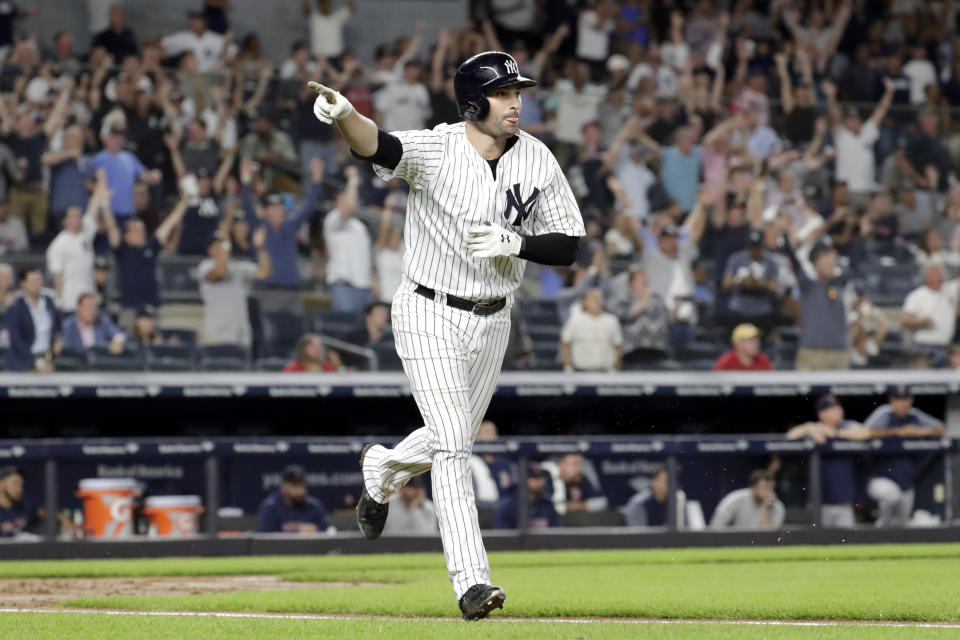 New York Yankees’ Neil Walker gestures toward the dugout after hitting a three-run home run off Boston Red Sox relief pitcher Ryan Brasier during the seventh inning of a baseball game Tuesday, Sept. 18, 2018, in New York. (AP Photo/Julio Cortez)