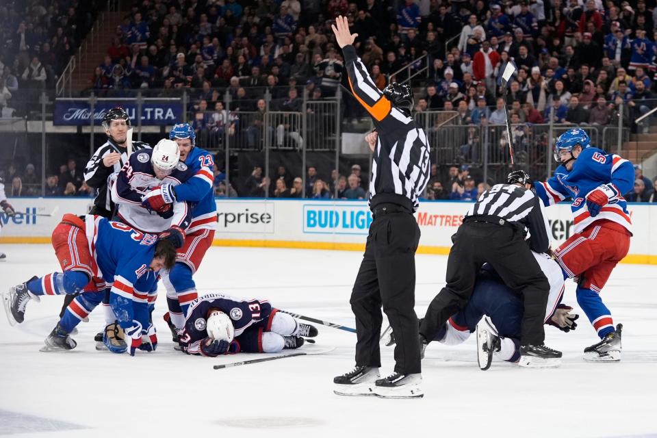 New York Rangers' Adam Fox (23) grabs Columbus Blue Jackets' Mathieu Olivier (24) as officials break up a fight during the second period of an NHL hockey game Wednesday, Feb. 28, 2024, in New York. (AP Photo/Frank Franklin II)