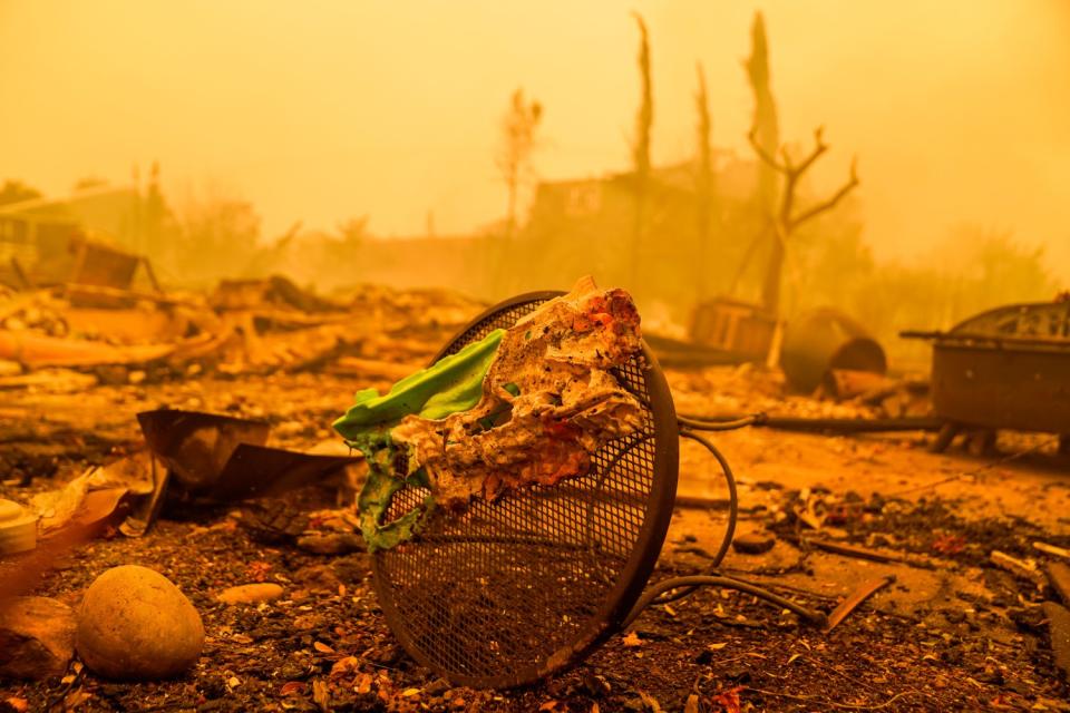 A plastic wager gun is melted to a small outdoor table amid an orange-y landscape.