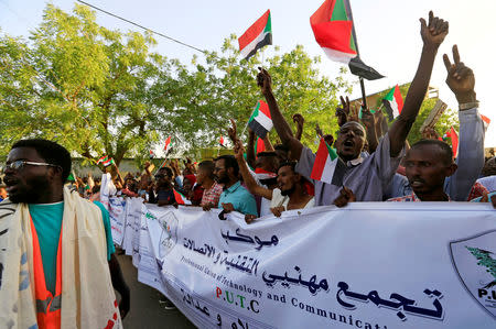 Sudanese demonstrators wave their national flags as they attend a mass anti-government protest outside Defence Ministry in Khartoum, Sudan April 21, 2019. REUTERS/Mohamed Nureldin Abdallah