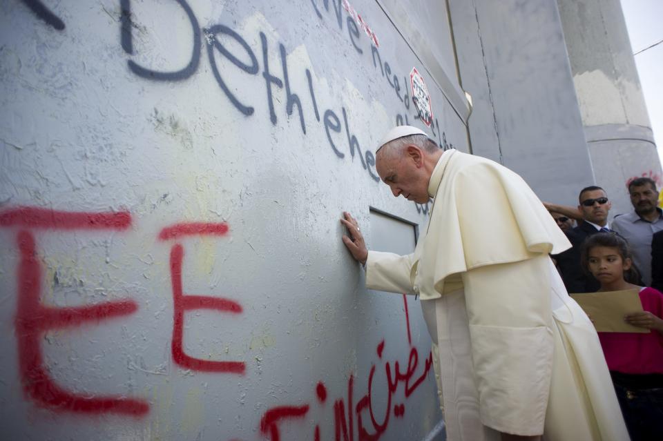 Pope Francis touches the wall that divides Israel from the West Bank in the West Bank city of Bethlehem