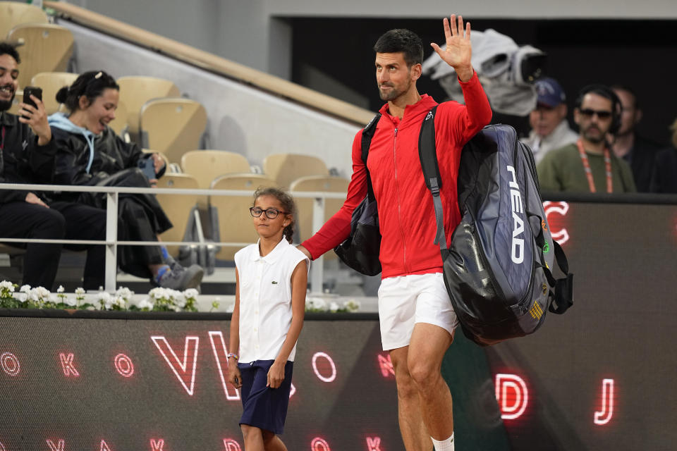 Serbia's Novak Djokovic enters center court for his first round match against Japan's Yoshihito Nishioka at the French Open tennis tournament in Roland Garros stadium in Paris, France, Monday, May 23, 2022. (AP Photo/Michel Euler)