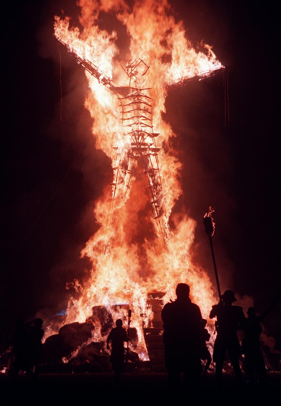 Hold for Story moving for Sunday AM's: In this file photo taken Sunday, Sept. 6, 1998, the 40-foot tall Burning Man is ignited to signal the end of the week-long Burning Man Festival held on the Black Rock Desert near Gerlach, Nv. It's never been so hard to be a hippie. A quarter century after the free spirits moved their party from San Francisco's Baker Beach to a dried up ancient lake bed 110 miles north of Reno, the Burning Man counterculture festival is faced with turning large numbers of its longtime participants away. With its drum circles and decorated art cars, guerilla theatrics and colorful theme camps, the annual pilgrimage to the playa in the name of both everything and nothing has become just too darn popular for its own good. (AP Photo/Reno Gazette Journal, Roger Duncan) NO SALES; MAGS OUT; NEVADA APPEAL OUT; SOUTH RENO WEEKLY OUT