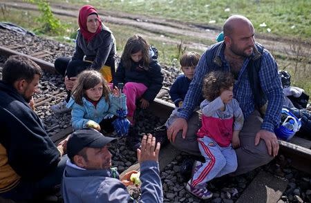 Migrants take a rest after crossing into the country from Serbia at the border near Roszke, Hungary September 12, 2015. REUTERS/Dado Ruvic