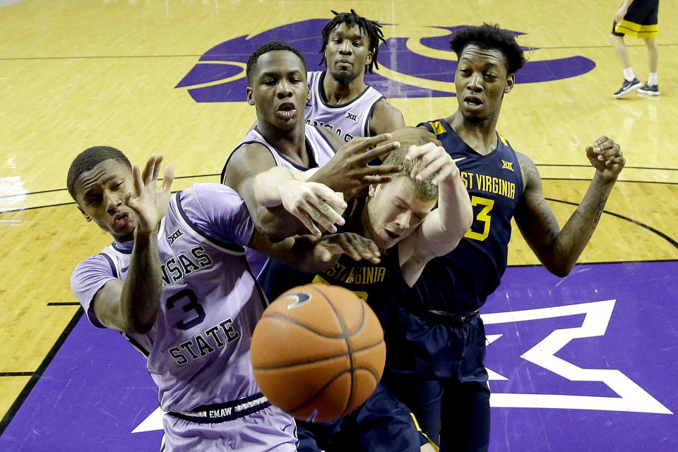 Kansas State's DaJuan Gordon (3) and West Virginia's Sean McNeil battle for a loose ball during the second half of an NCAA college basketball game Saturday, Jan. 18, 2020 in Lawrence, Kan. Kansas State won 84-68. (AP Photo/Charlie Riedel)