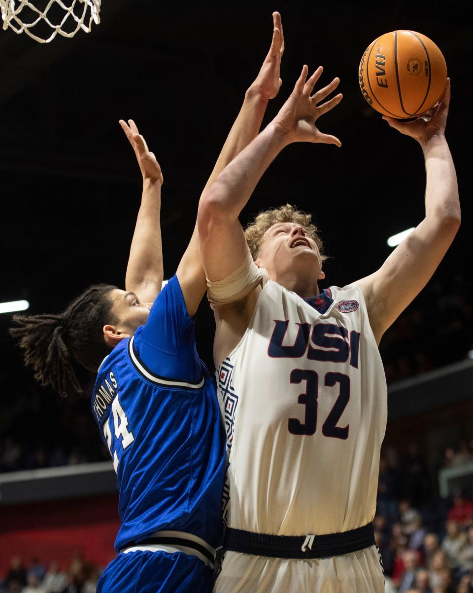 Southern Indiana’s Jacob Polakovich (32) goes up against Eastern Illinois’ Kyle Thomas (24) as the University of Southern Indiana Screaming Eagles play the Eastern Illinois University Panthers at Screaming Eagles Arena in Evansville, Ind., Thursday, Jan. 26, 2023.