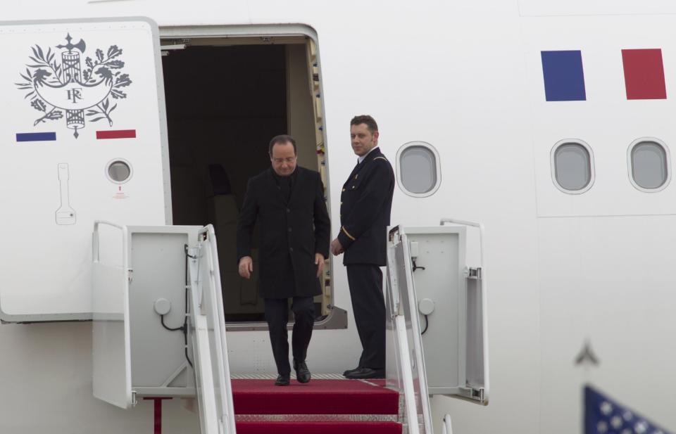 French President Francois Hollande steps out his plane upon arrival at Andrews Air Force Base, Md., Monday Feb. 10, 2014, for a three-day visit to U.S., including a state dinner hosted by President Barack Obama. (AP Photo/Jose Luis Magana)