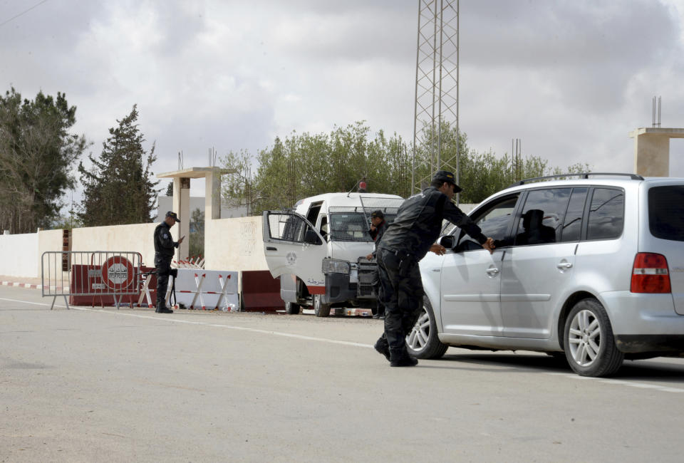 A police officer checks a car near Ghriba synagogue in Djerba, Tunisia, Wednesday May 10, 2023. Tunisia's TAP news agency says the death toll from a gun attack near a Synagogue on the Mediterranean island of Djerba has risen to five. The victims were two people attending an annual Jewish pilgrimage and three Tunisian police guards. (AP Photo/Moncef Abidi)