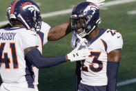 Denver Broncos cornerback Michael Ojemudia, right, is congratulated by De'Vante Bausby, left, after he forced a New England Patriots fumble in the second half of an NFL football game, Sunday, Oct. 18, 2020, in Foxborough, Mass. (AP Photo/Steven Senne)