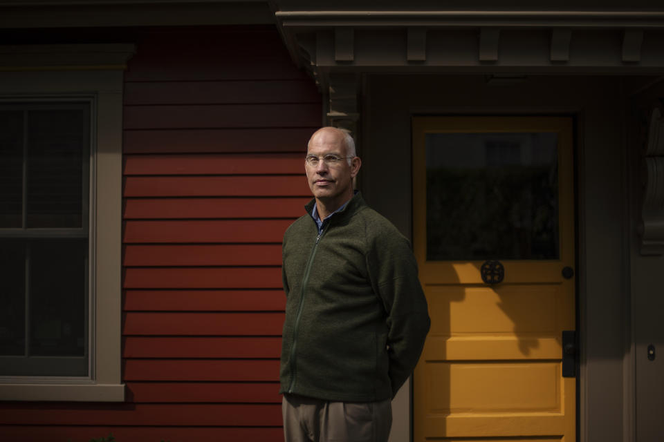 Seth Handy, 53, a direct descendant of a Pilgrim who came over on the Mayflower, stands for a portrait outside his home in Providence, R.I., Tuesday, Sept. 22, 2020. For Handy, it's a difficult issue to reconcile. "The pilgrims came out of religious persecution in England. And I'm very proud of the fact that they set off to create their own independent culture," said Handy. "But they came to a place where there was existing culture. And, you know, the history is not friendly and that is troublesome," he said. Handy added that it's more important now than ever now to "recognize everyone's role in our history and the great diversity of this country." (AP Photo/David Goldman)