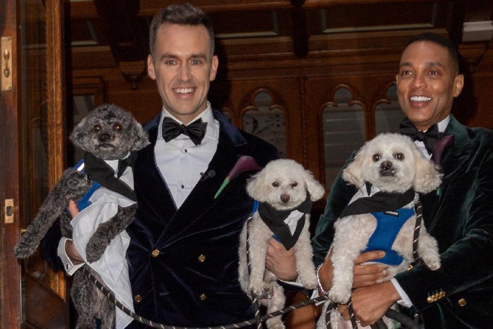 Don Lemon and Tim Malone holding their dogs as they exit the ceremony (Photo by MEGA/GC Images)