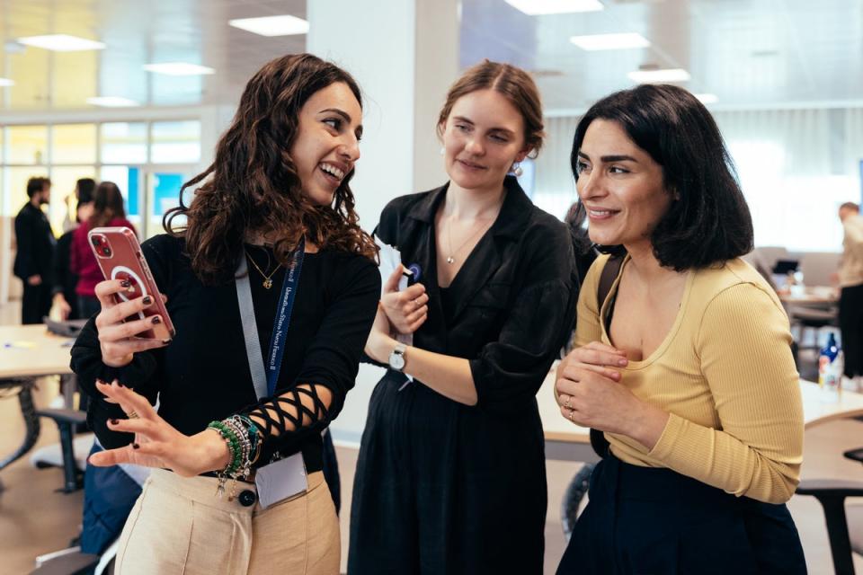 An Apple Developer Academy student shows their app to Melissa Würtz Azari, co-founder and CPO, and Signe Bentzen, Lead Product Designer, of Tiimo (Apple)