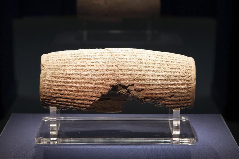 In this image provided by The Smithsonian Institution, the Cyrus Cylinder is seen on display at the Smithsonian's Freer Sackler Gallery in Washington. The 2,500-year-old Babylonian artifact sometimes described as the world's first human rights charter will be shown for the first time in the United States at the gallery, followed by stops in New York, Houston and Los Angeles. The British Museum is loaning the cylinder, which carries an account of how Persian king Cyrus conquered Babylon in 539 B.C. and restored people held captive to their homelands. (AP Photo/The Smithsonian Institution, John Tsantes)