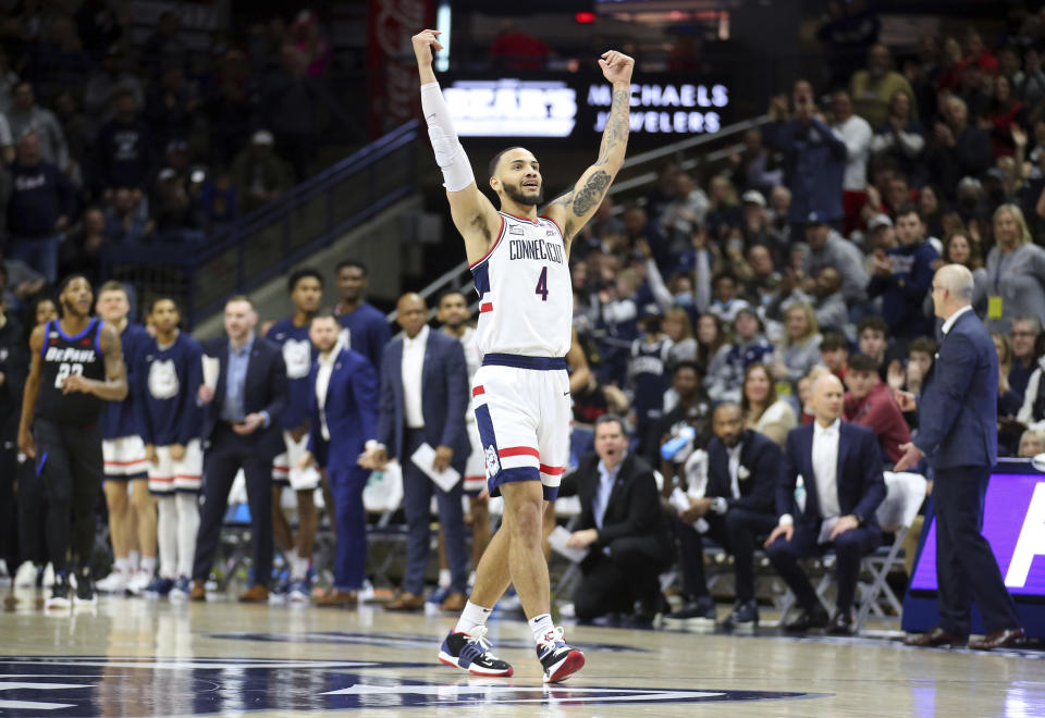 Connecticut's Tyrese Martin (4) celebrates during the first half of an NCAA college basketball game against DePaul Saturday, March 5, 2022, in Storrs, Conn. (AP Photo/Stew Milne)