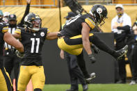 Pittsburgh Steelers running back James Conner (30) leaps after scoring a touchdown against the Cleveland Browns during the first half of an NFL football game, Sunday, Oct. 18, 2020, in Pittsburgh. Steelers wide receiver Chase Claypool (11) also reacts. (AP Photo/Don Wright)